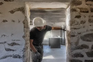 Chantier de rénovation avec découpe d'un mur porteur pour une cuisine maison en pierre